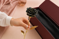 Woman holding the 24K Gold Dipped Rose in Luxury Box - Black Gold Rose